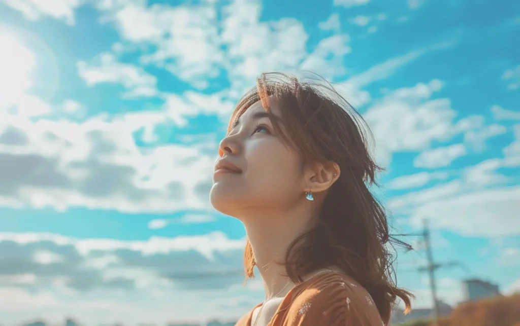 a woman looking up at the sky with positivity